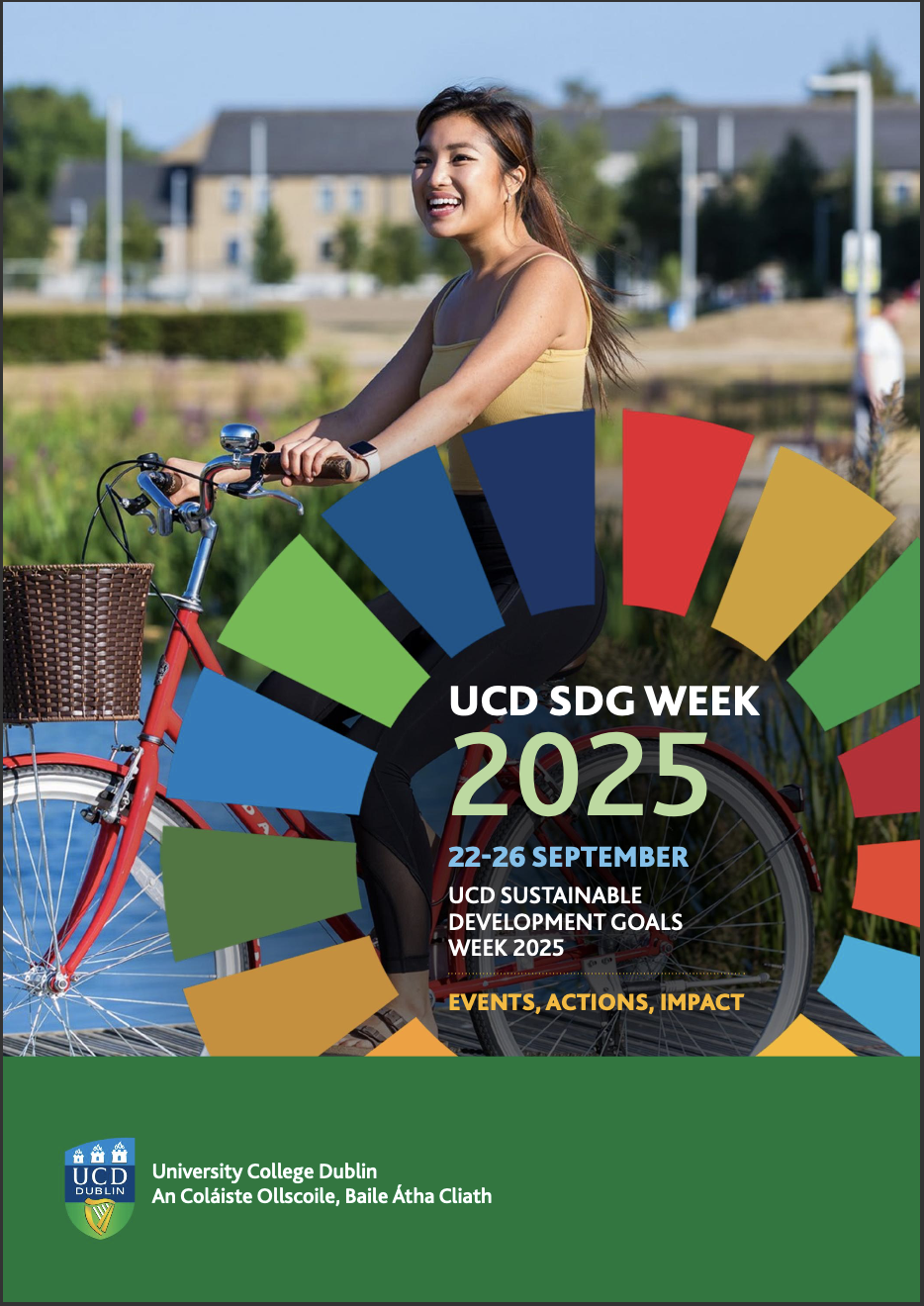 Student riding a red bike with UCD lake and residences in the background